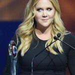 Amy Schumer smiling on stage