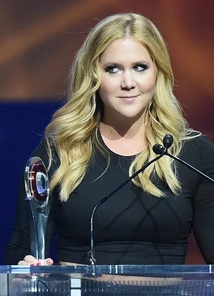 Amy Schumer smiling on stage