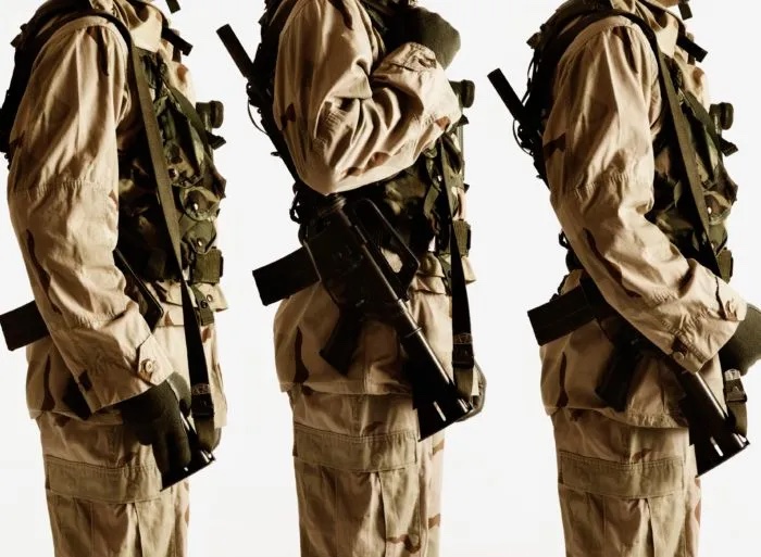 military people; three people dressed in military wear with weapons