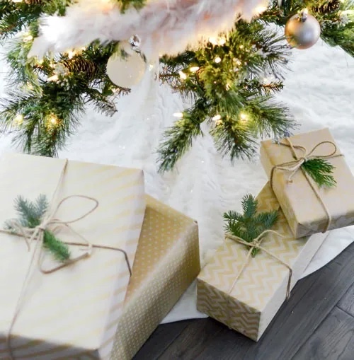 white holiday presents under tree; white gifts; Christmas gifts under tree