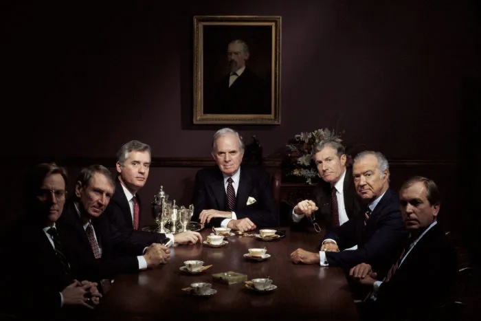 7 businessmen at a table; table of board of directors; board of directors; business people at table
