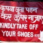 Kindly take off your shoes sign in two languages