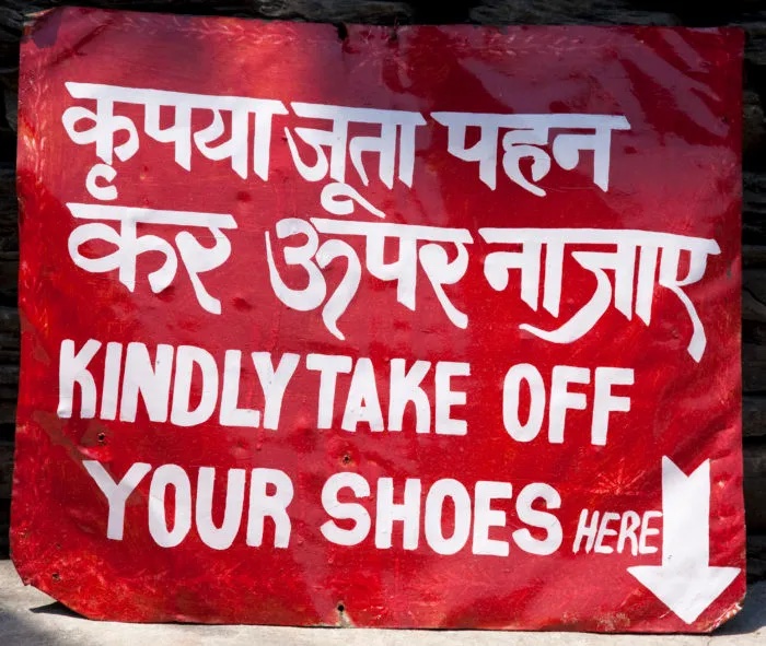 Kindly take off your shoes sign in two languages