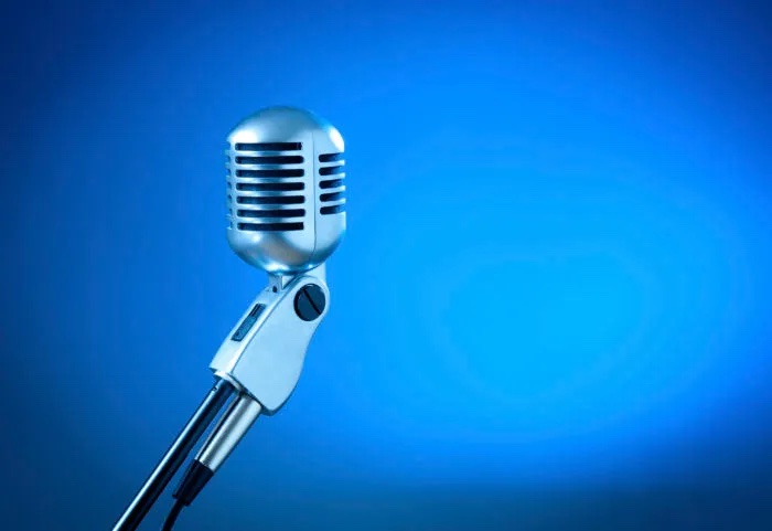 old school microphone with blue background