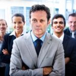 five business people; professionals smiling at camera