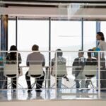 work meeting; meeting room with glass walls; group meeting; business presentation